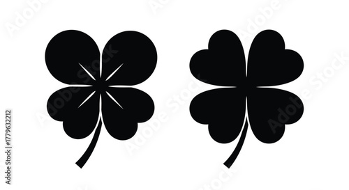 Simple black and white illustration of two four leaf clovers visible