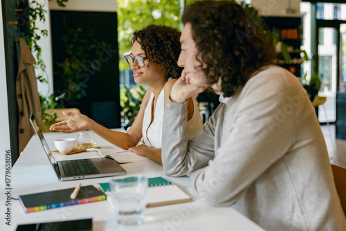 partners analyze project sketches together, collaborative workspace focused on visual planning