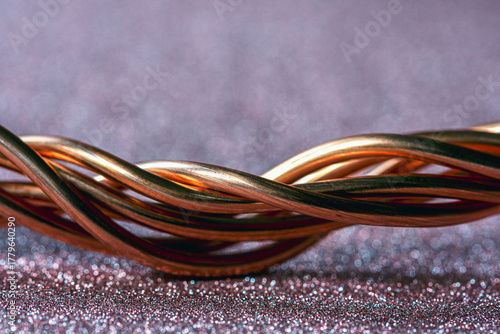 Twisted copper wire close-up on glitter sparkle photography backdrop