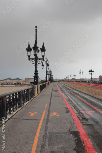 Pedestrian and bike paths on bridge with lanterns. Bordeaux, France