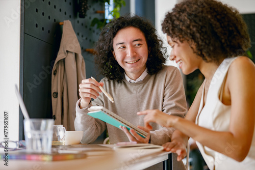 two students from different backgrounds engaging in relaxed and cheerful study discussion at coffee