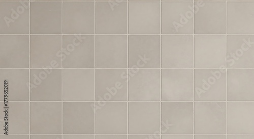 A grid of square beige tiles with thin white grout lines, creating a clean and uniform surface pattern
