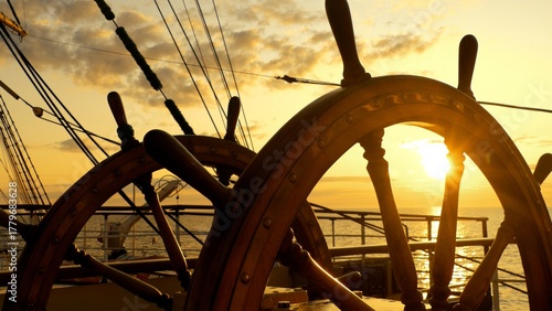 at sea at sunset at the old ship's wheel