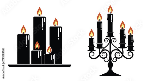 Elegant black candles with flickering flames isolated on white background