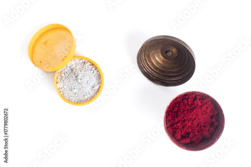 Colorful powders in open containers, white thiruneer powder and kumkum powder are part of the Hindu culture