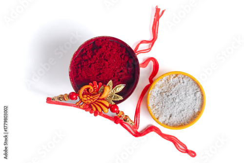Festive decorative rakhi bangle with white and red powder on white background