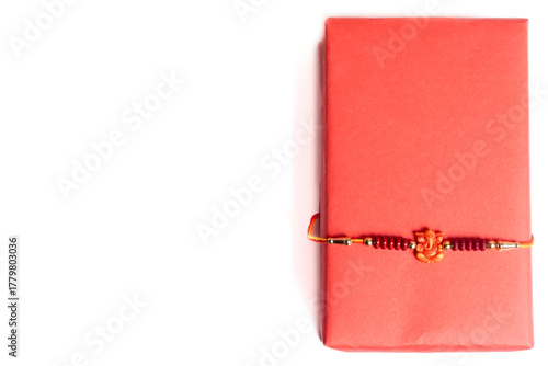 Elegant gift for Raksha Bandhan celebration, a red gift box wrapped with a red bangle ribbon.