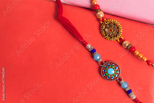 Colorful beaded bracelet jewelry with intricate circular pendants on a red background