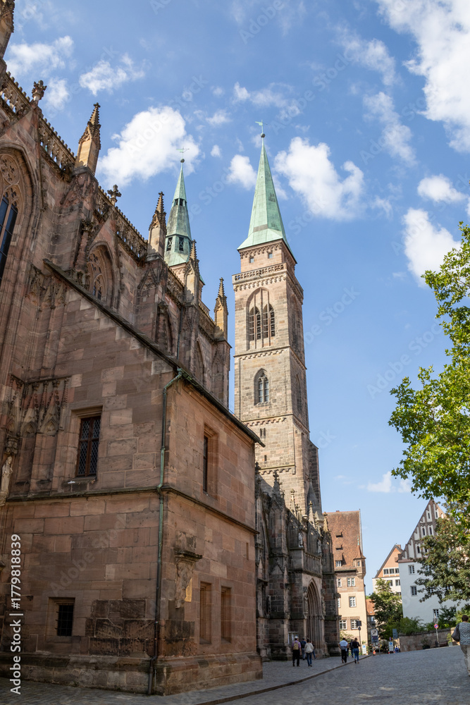 Fototapeta premium St. Sebald Church in Nuremberg, Germany, a Gothic Lutheran landmark with impressive stained-glass windows, artwork, and a grand historic organ in the old town.