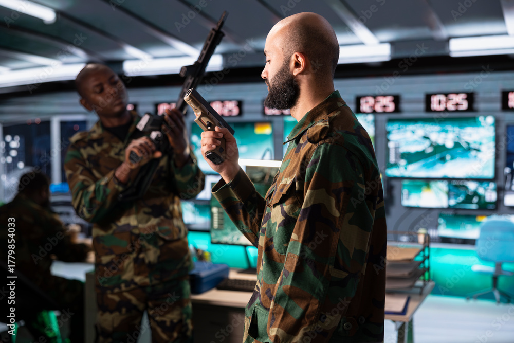Fototapeta premium Middle Eastern army solder packing pistol able to engage targets at extended range with accurate, lethal fire. Armed forces troops reloading guns, preparing to start assault mission during global war