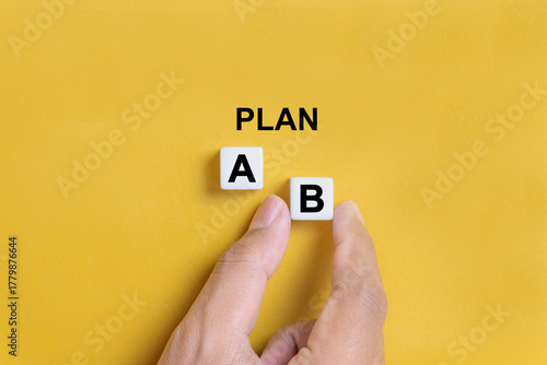 Hand of a businessman choosing business plan b out of two options