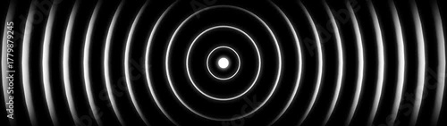 Abstract concentric circles with bright light in the center on a dark background image photo