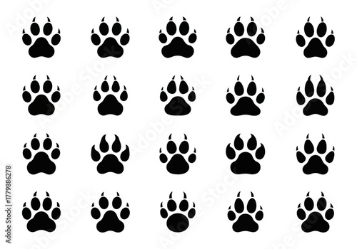 A collection of black silhouette paw prints arranged in a grid pattern. This vector illustration set features animal tracks from a dog, wolf, or fox
