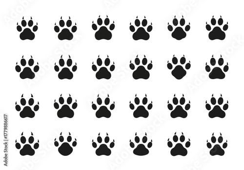 Vector collection of animal paw print silhouettes. A grid pattern of black dog, cat, and wolf track icons isolated on white background