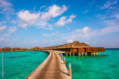 Fototapeta Naklejka Na Ścianę i Meble -  Wooden pathway to bungalows. Summer vacation, holiday amazing nature. Relax paradise, Maldives. Tropical island beach landscape exotic shore coast. Tranquil closeup calm sea water waves.