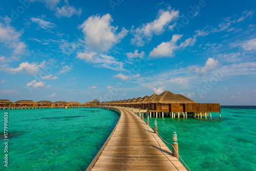 Fototapeta Naklejka Na Ścianę i Meble -  Wooden pathway to bungalows. Summer vacation, holiday amazing nature. Relax paradise, Maldives. Tropical island beach landscape exotic shore coast. Tranquil closeup calm sea water waves.