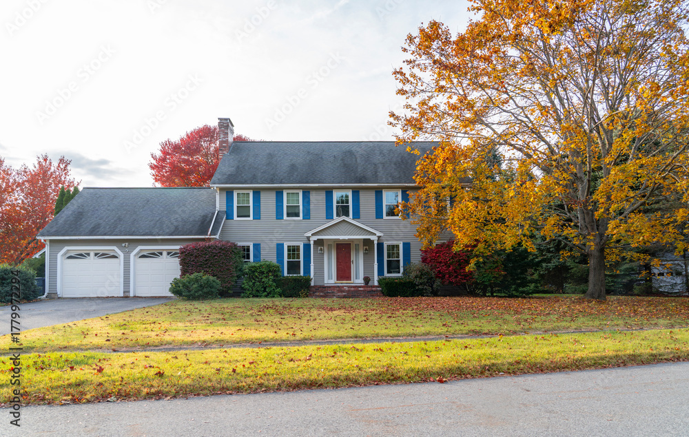 Obraz premium residential house with colorful autumn trees