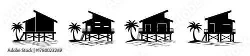 A row of four silhouetted stilt houses with palm trees and shadows on a beach.