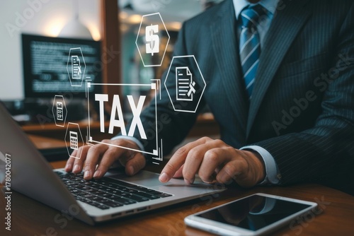 Businessman working on laptop with tax icons and digital interface