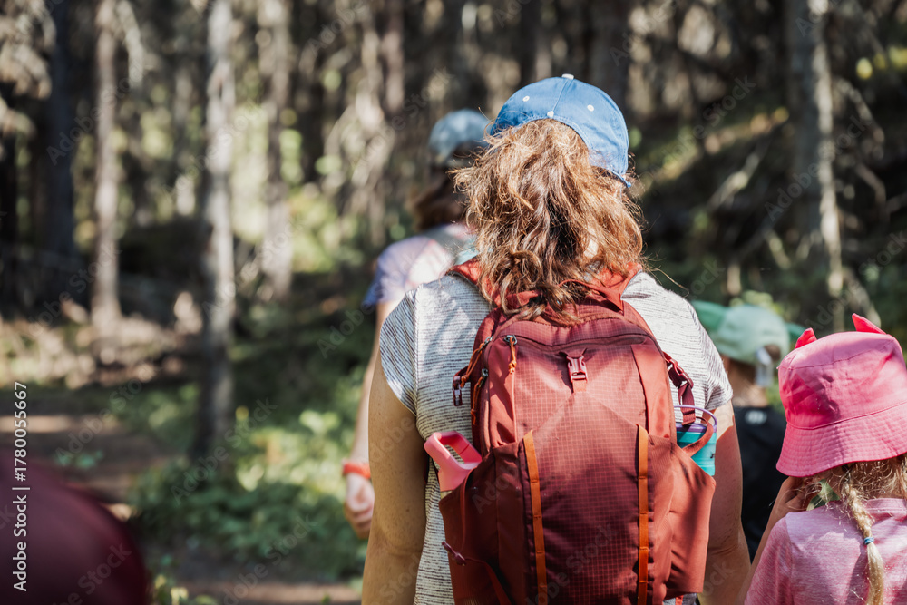 Naklejka premium defocused Family enjoys a hiking adventure in a forested area during a cloudy day