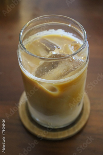 Perfectly Layered Iced Coffee Latte Close-up on Coaster
