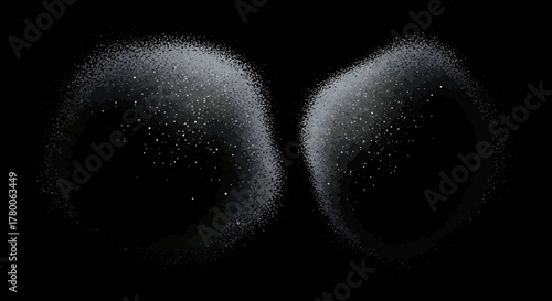 Abstract image of two fuzzy, glowing orbs against a black background.