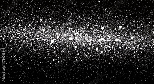 A dense, glittering band of white stars and nebulae against a deep black background, resembling a galaxy or cosmic dust cloud.