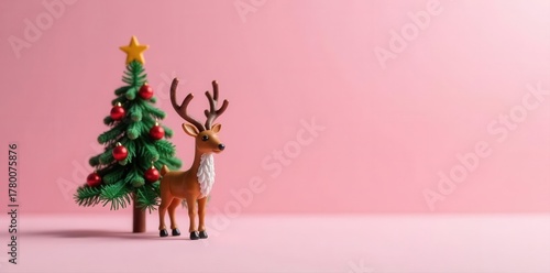 Miniature fir tree reindeer, red bauble antlers Pastel pink background , adorable, evergreen, festive decoration