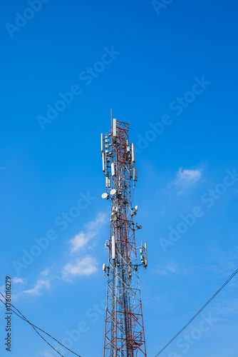 Telecommunication high tower with cellular network antennas on blue sky background. Satellite pole communication technology industry. 