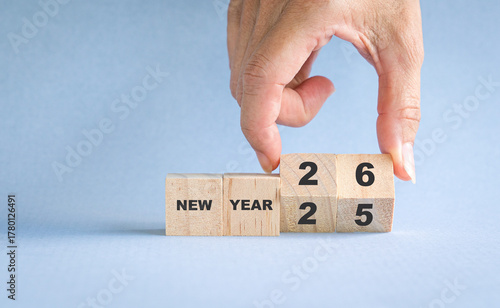 Hand turning wooden block from New year 25 to 26