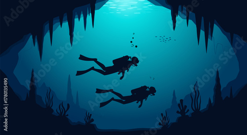 Silhouettes of two scuba divers exploring the mysterious depths of a submerged underwater cave with stalactites and light rays