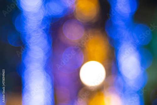 Bokeh lights abstract background blue gold. A dynamic, intense mix of blurred blue, purple, and gold holiday lights creates an energetic, vibrant, and festive visual pattern