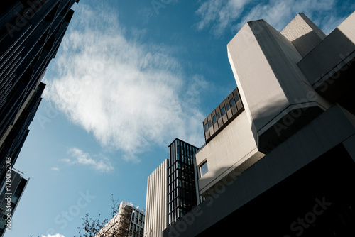 Brutalist architecture building details rising to blue sky