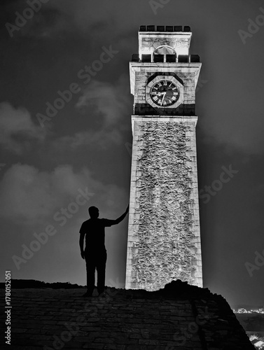 silhouette of a man with clock tower