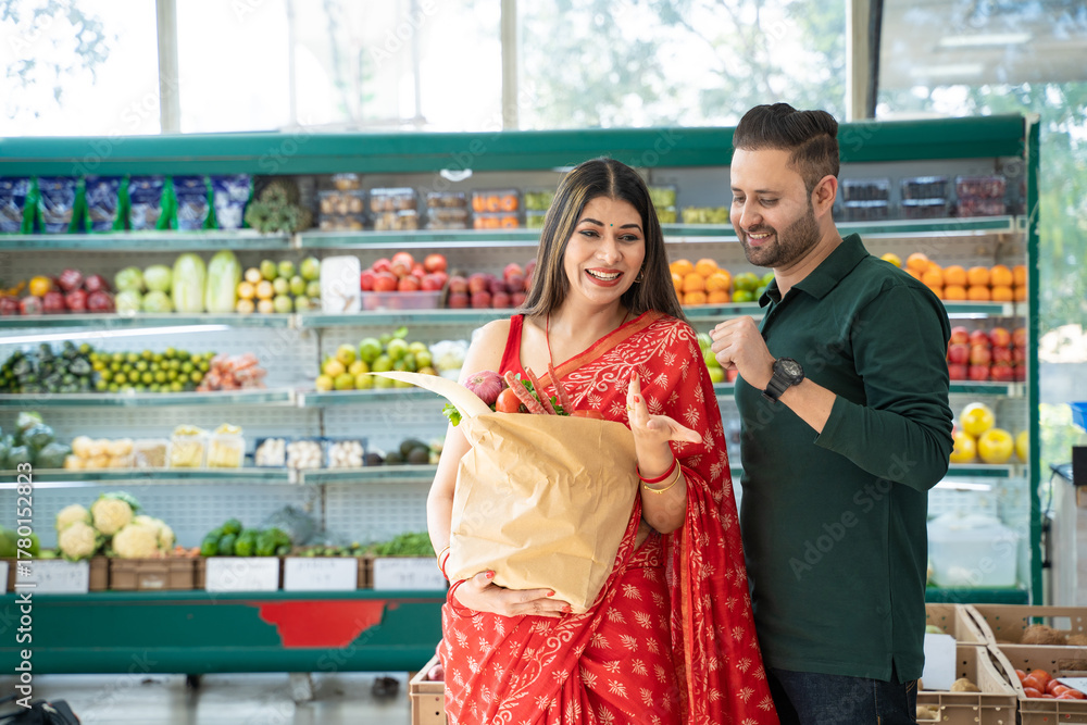 Obraz premium Indian couple purchasing vegetables at super shop.