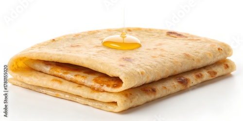 puran poli flatbread folded in half with golden ghee drop
