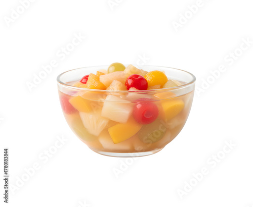 A side view of a bowl filled with canned fruit cocktail, set against a white background.