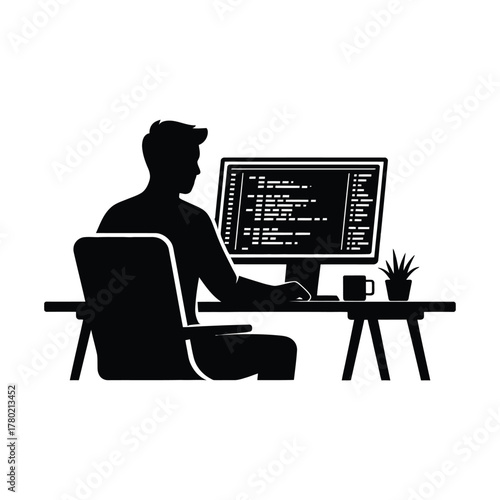 Silhouette of a programmer coding on a computer at a desk
