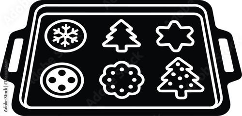 Baking sheet with six christmas cookie cutters ready for dough