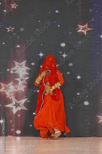 Portrait of an unidentified female artist performing classical dance in ethnic indian clothes.