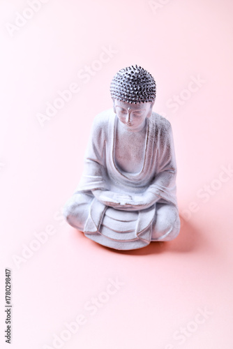 Meditating Buddha Statue on bright background. Soft focus. Copy space	