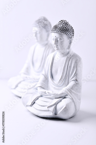 Meditating Buddha Statue on bright background. Soft focus. Copy space	