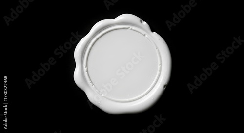 A white circular wax seal with an irregular edge set against a solid black background