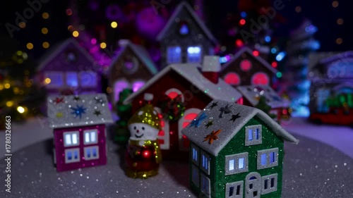 In front of the big Christmas town, a small town with beautiful houses is spinning
