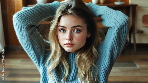 Young woman poses with soft expression in cozy indoor setting during afternoon light