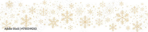 A delicate, festive pattern of golden snowflakes is beautifully arranged against a clean white backdrop, evoking a sense of winter and holiday cheer.
