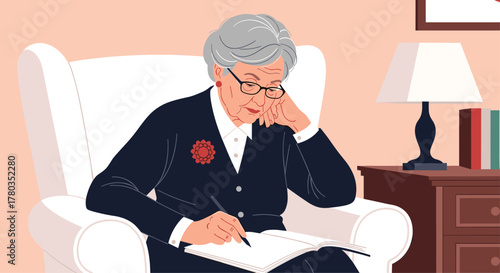 Elegant elderly woman with glasses sits comfortably in a white armchair while thoughtfully writing her memoirs or journaling in a book.