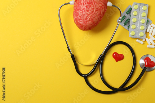Tableau sur toile Medical stethoscope, red heart and cardiogram on a color background