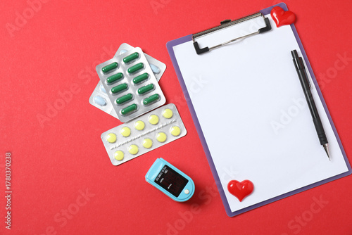 Canvas Print Medical stethoscope, red heart and cardiogram on a color background