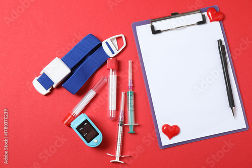 Photos Medical stethoscope, red heart and cardiogram on a color background